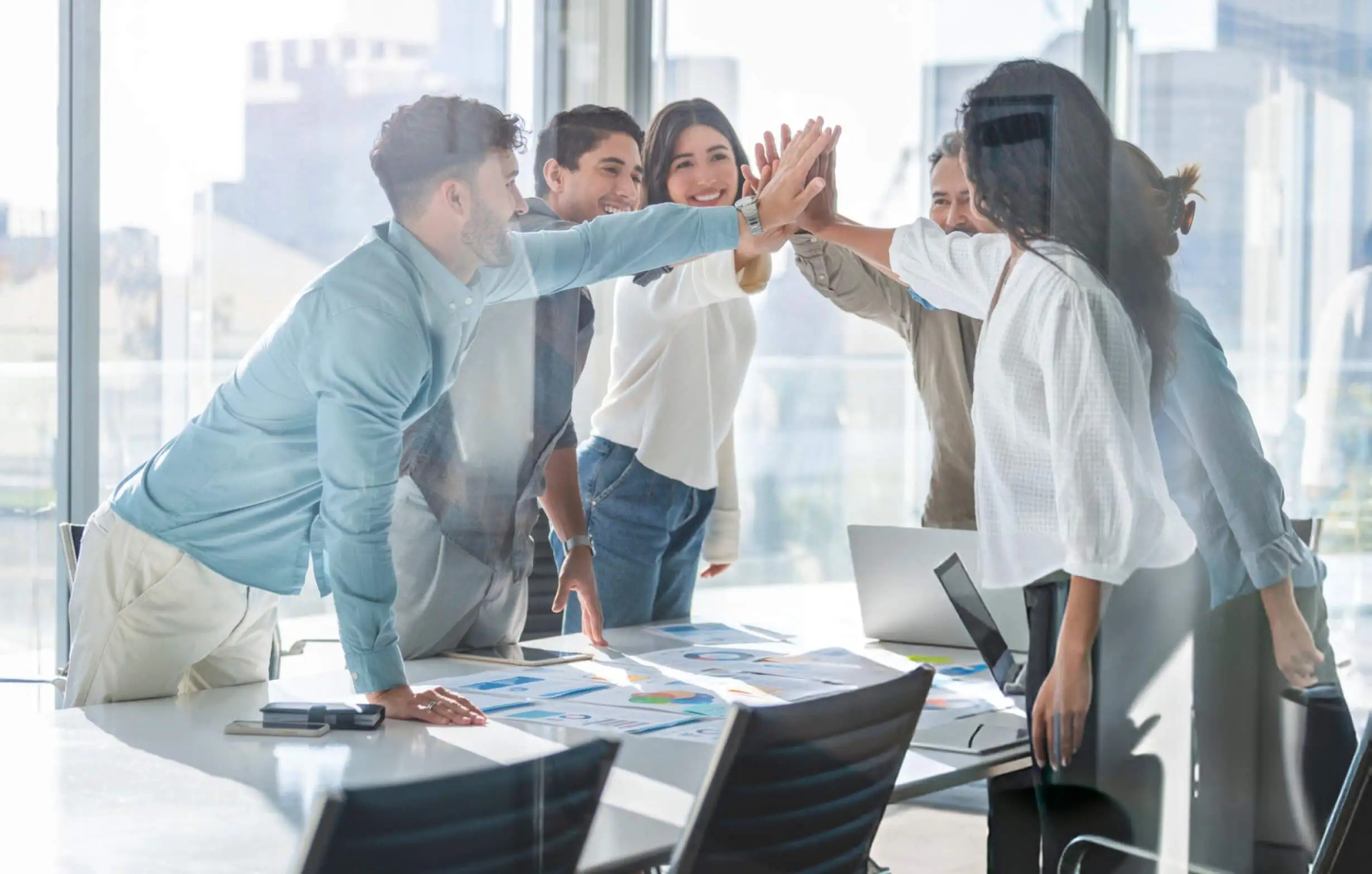 Business team celebrating success with a high five 