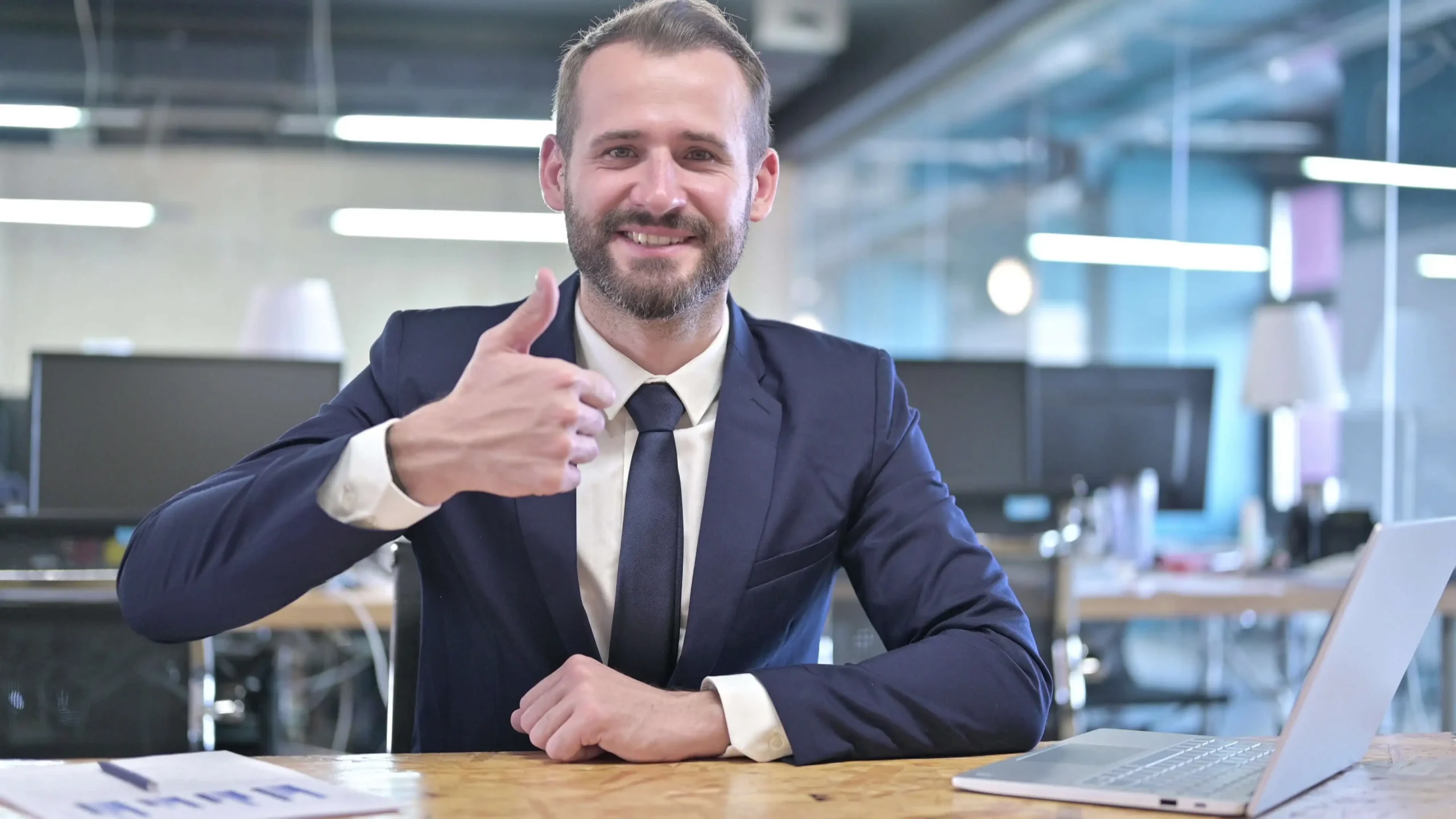 Cheerful Young Businessman showing Thumbs Up for happy consulting